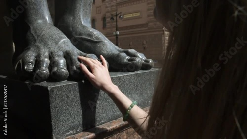 Close up of woman hands on Atlant feets in Saint Petersburg Russia photo