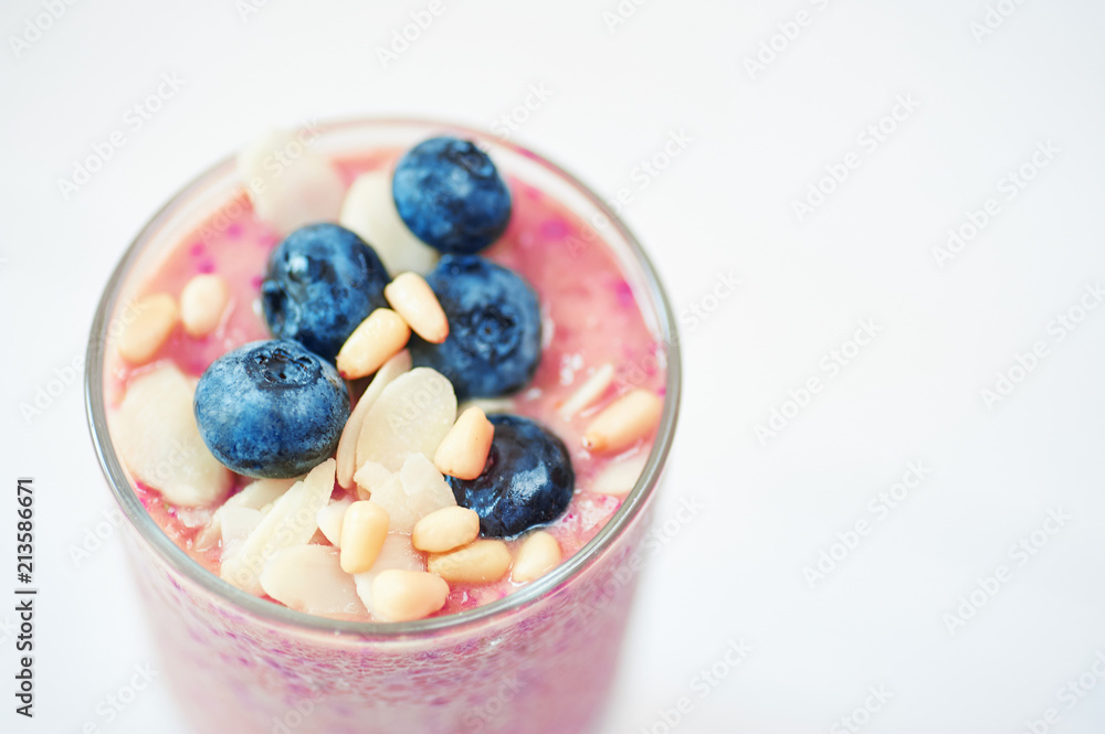 Glass of pink fruit smoothies milkshake or cocktail on white background, breakfast vegan, with a place for your text, concept of raw food Glass of pink fruit smoothies milkshake or cocktail on white background, breakfast vegan, with a place for your text, concept of raw food