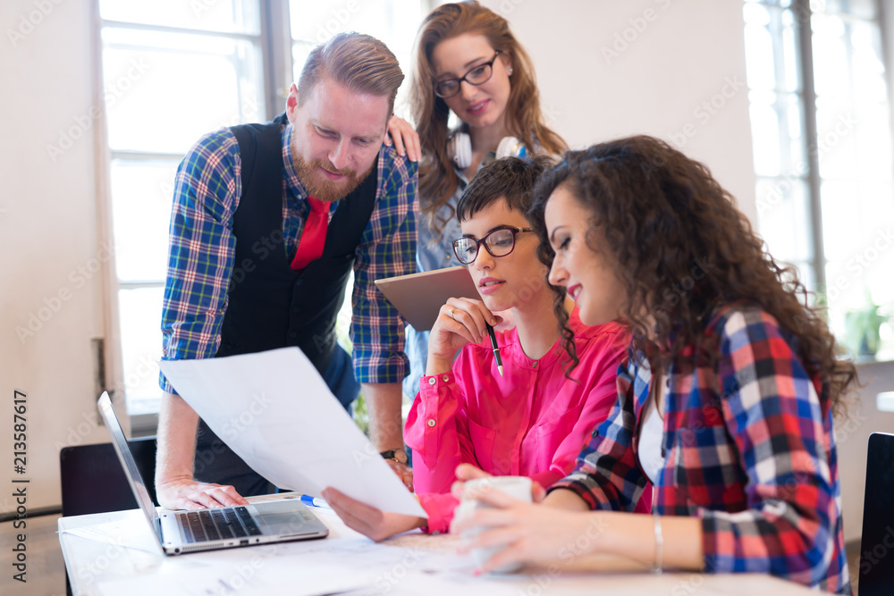Picture of young architects discussing in office Picture of young architects discussing in office