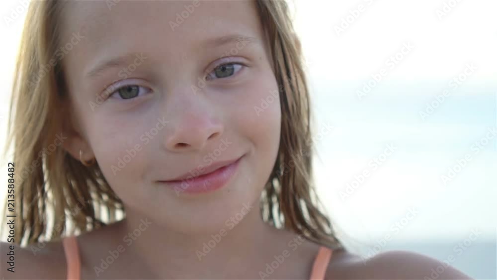 Happy little girl enjoying holiday vacation on the beach Happy little girl enjoying holiday vacation on the beach