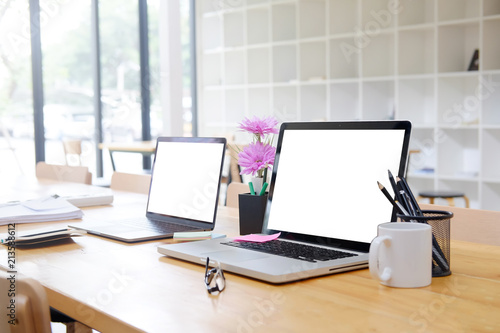 Mockup two computer laptop on business office with empty screen display.