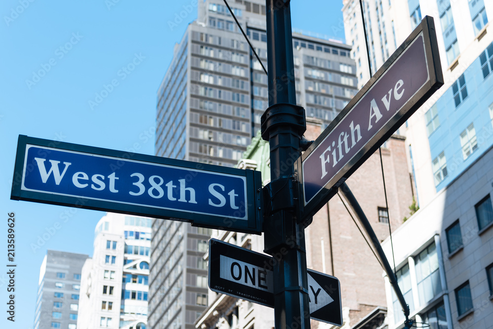 Low angle view of road sign in city Low angle view of road sign in city