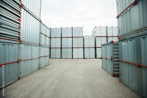 Abundance of sealed metal cargo containers stacking outdoors, shipping storage