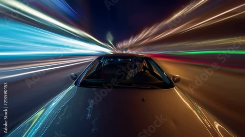Speed driving on car in night a city with neon glows and motion blured lights. Timelapse video