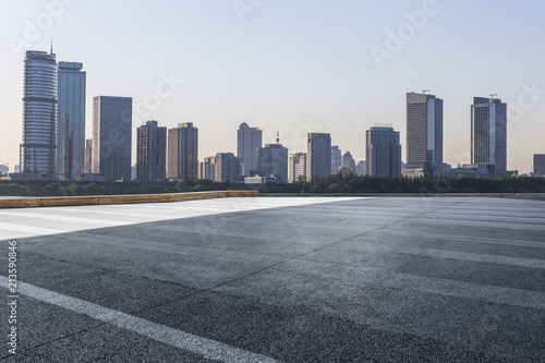 Panoramic skyline and modern business office buildings with empty road empty concrete square floor