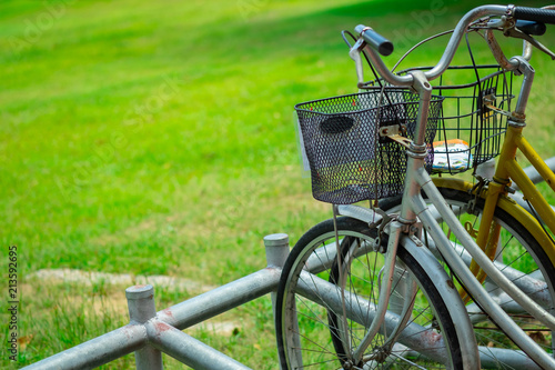Bicycle parking in public park on grass.