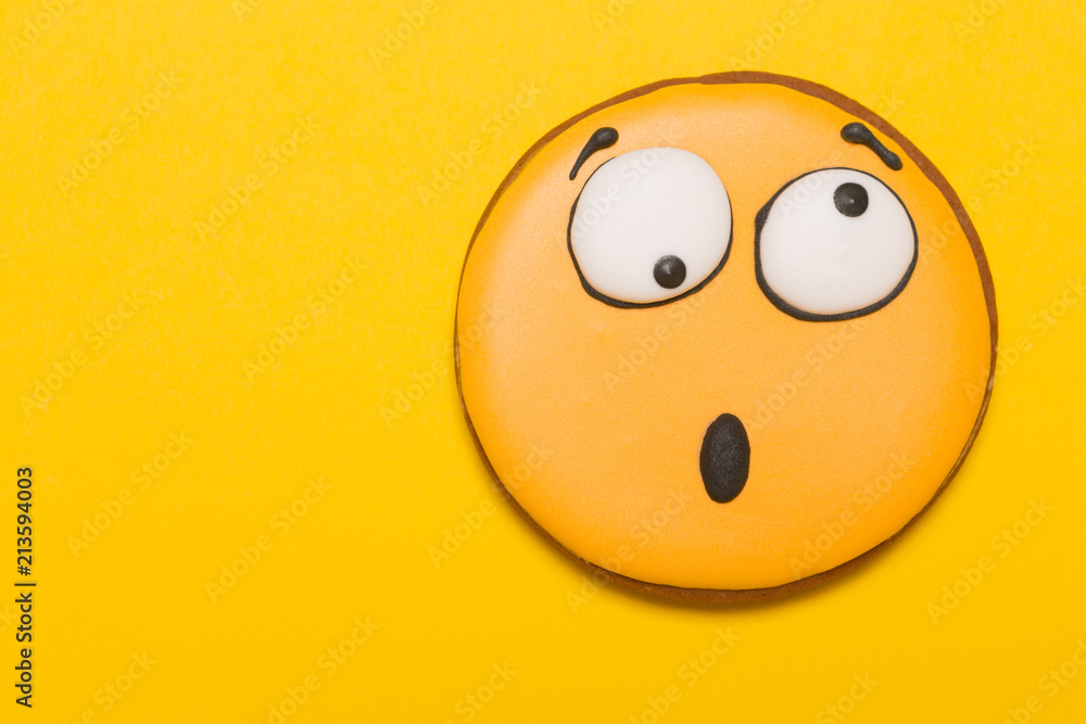 Fototapeta premium cookie smile and emotion, opened his mouth, surprise, baby gingerbread, on a yellow background, concept