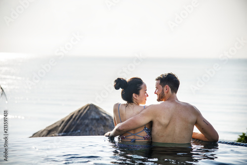 Couple relaxing in a swimming pool photo