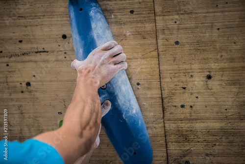 Man bouldering and climbing indoor