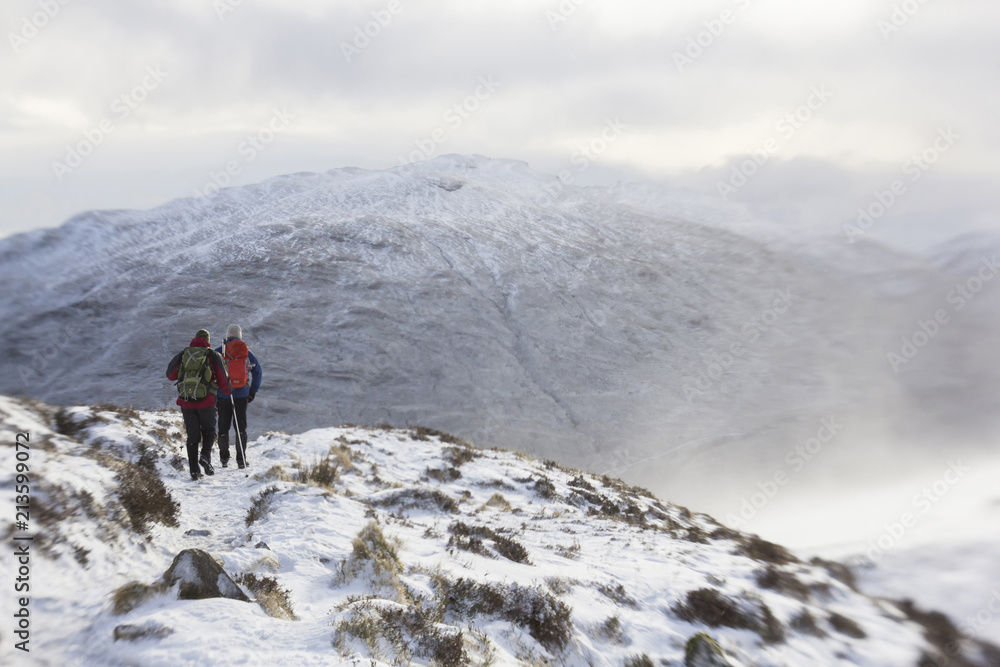 Naklejka premium Winter climbers on a snow covered mountain in Scotland