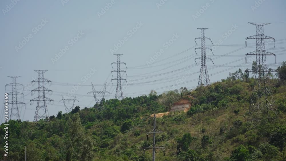 Power pylons and high voltage lines passing through mountain cordillera