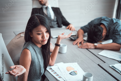 business woman and sleeping resting on workplace during work meeting. 