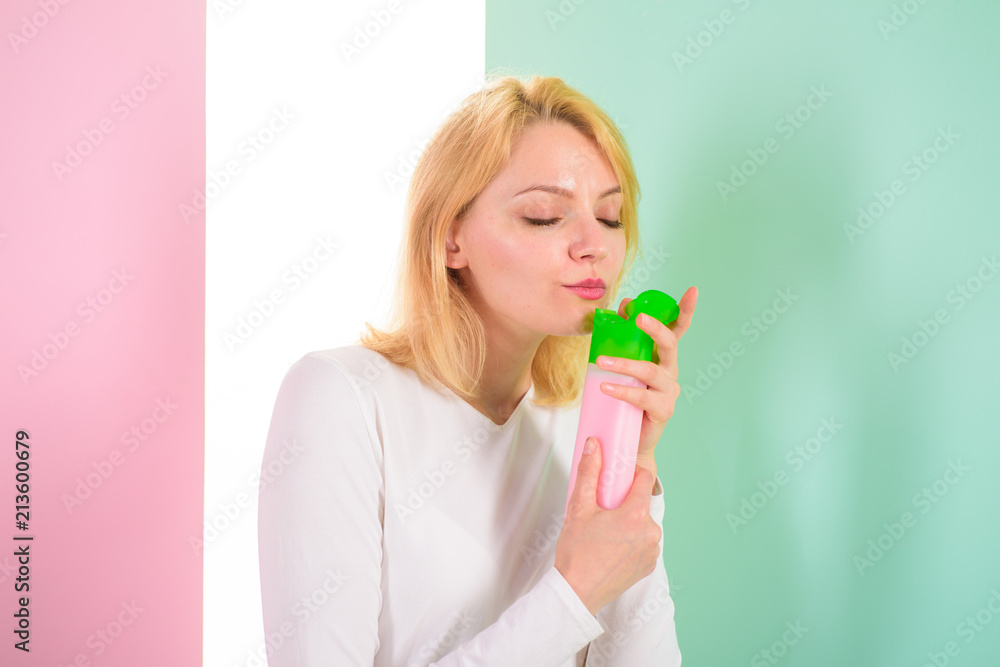 Pleasant aroma. Expert tips achieve incredible hair. Girl blonde holds shampoo bottle. Woman shows beauty product for hair. Hair treatment product. Girl holds shampoo bottle recommends product Pleasant aroma. Expert tips achieve incredible hair. Girl blonde holds shampoo bottle. Woman shows beauty product for hair. Hair treatment product. Girl holds shampoo bottle recommends product