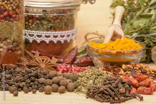 Various spices on wooden background. © brszattila