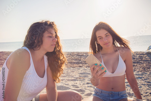 Teenage girls taking a selfie on sandy beach in Greece / Summer holidays / Teenage concept