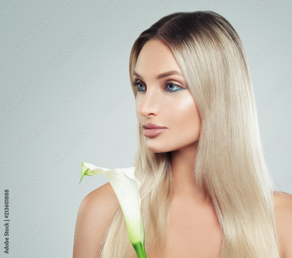 Cute Young Woman with Fresh Skin, Healthy Hair and Lily Flowers in her Hands. Facial Treatment, Cosmetology, Beauty, Skin Care and Spa. Portrait Cute Young Woman with Fresh Skin, Healthy Hair and Lily Flowers in her Hands. Facial Treatment, Cosmetology, Beauty, Skin Care and Spa. Portrait
