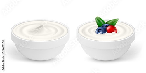 Ceramic bowls of white yogurt with berries isolated on white background