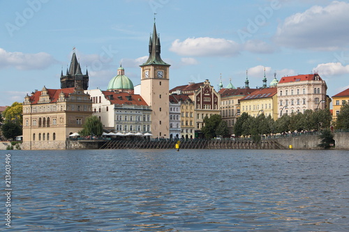 View of architecture near Charles Bridge from a boat on the river Vltava