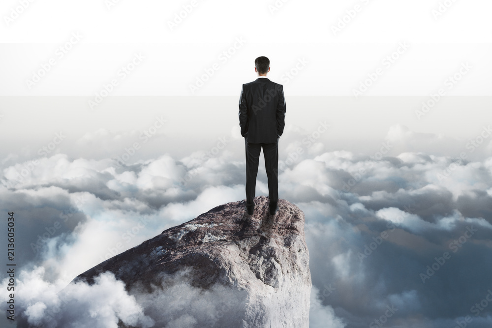 success concept with businessman onn top of rock success concept with businessman onn top of rock