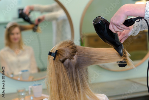 professional hairdresser drying hair