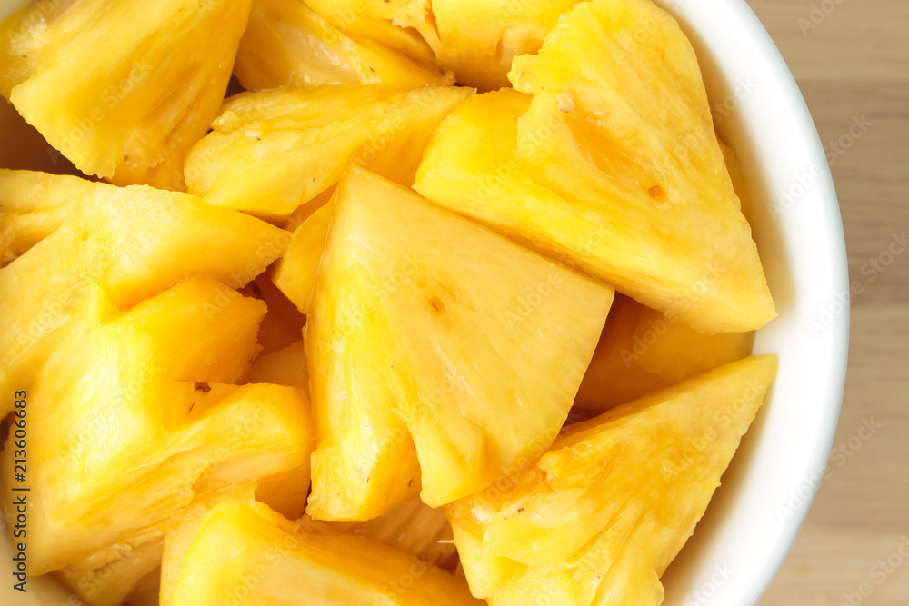 Pineapple slice on a plate placed on a wooden table. Pineapple slice on a plate placed on a wooden table.