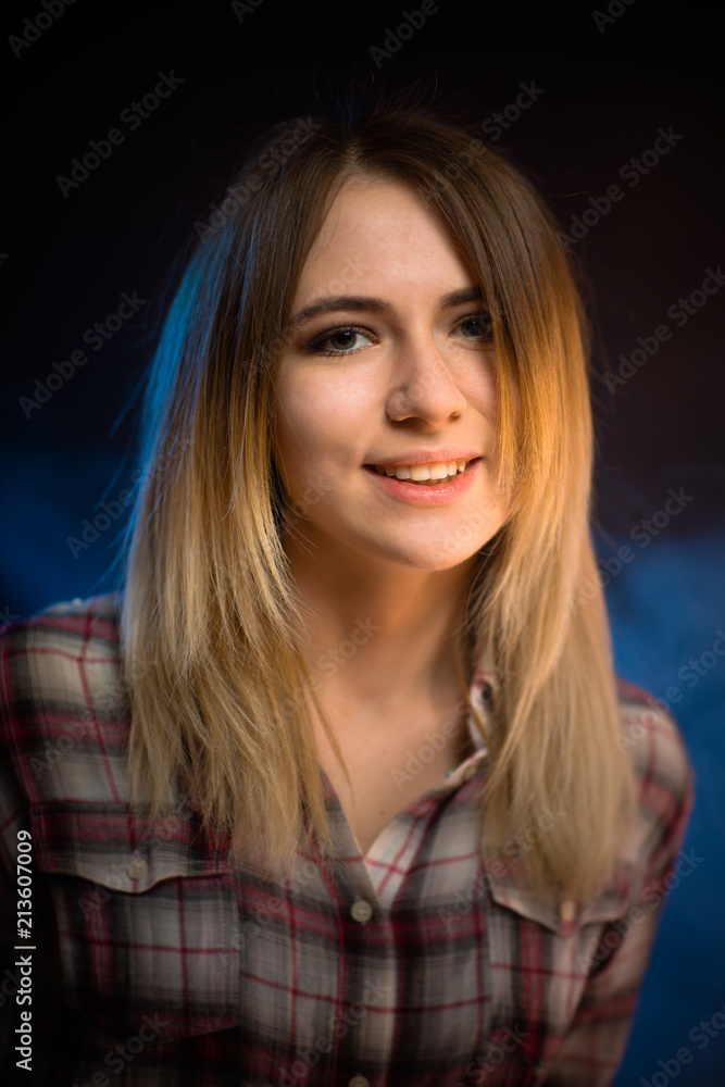 portrait smiling girl on blue background in studio portrait smiling girl on blue background in studio