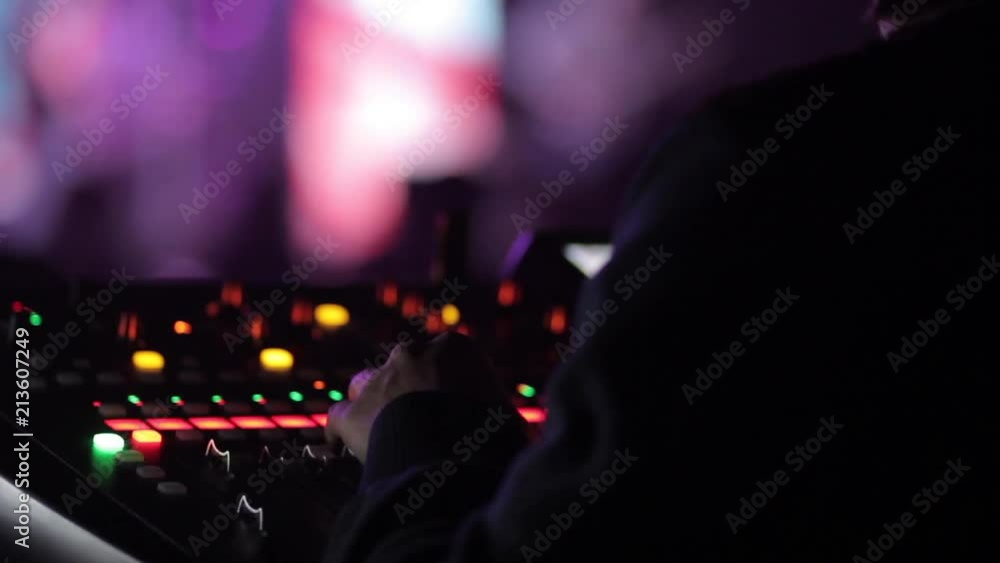 Close up of male's hands working on mixing desk Close up of male's hands working on mixing desk