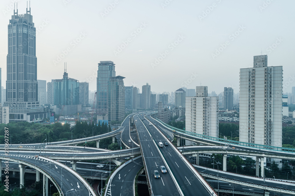 Fototapeta premium aerial view of buildings and highway of shanghai city in smoggy dawn