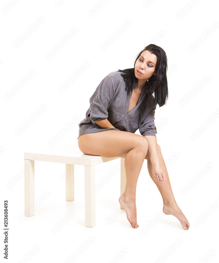 Emotional portrait of a beautiful girl with long hair, in a shirt, on a white background. Emotional portrait of a beautiful girl with long hair, in a shirt, on a white background.
