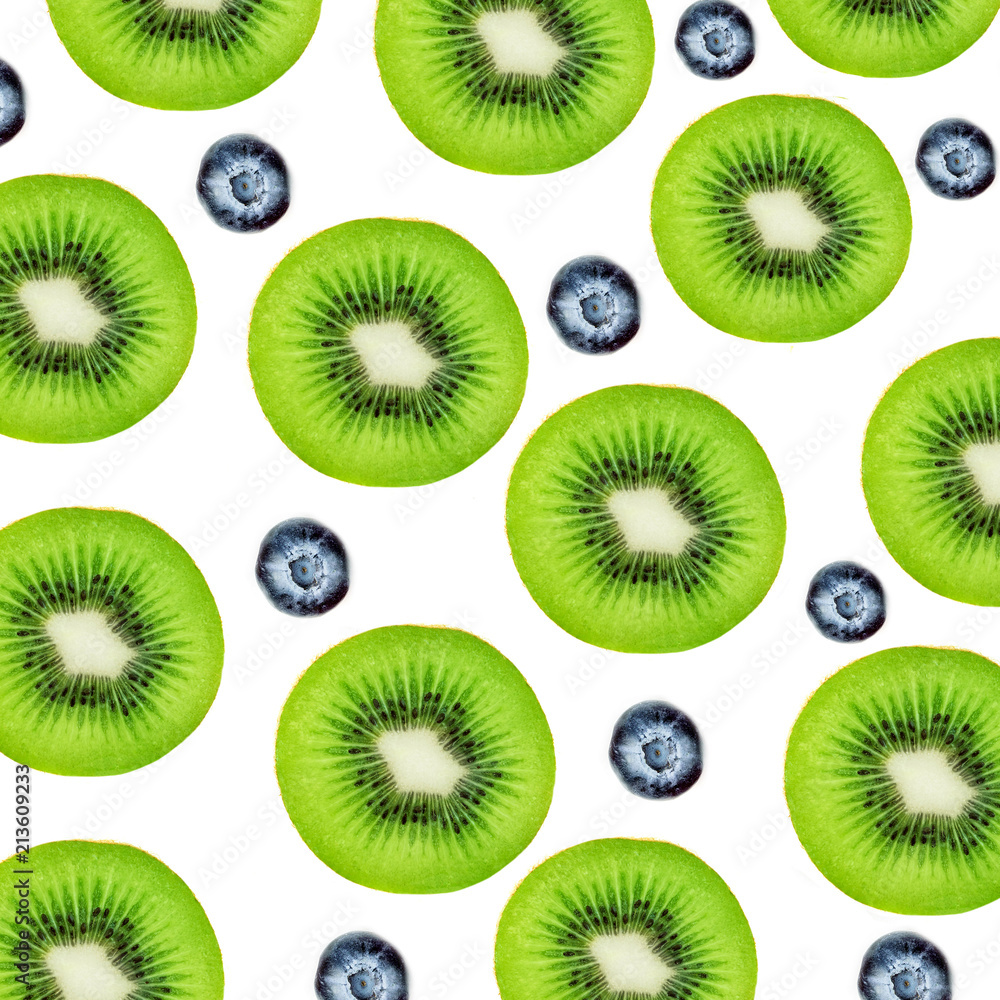Creative layout made of Kiwi fruits and blueberry. Many slices of ripe and juicy Kiwifruit. Flat lay. Creative layout made of Kiwi fruits and blueberry. Many slices of ripe and juicy Kiwifruit. Flat lay.