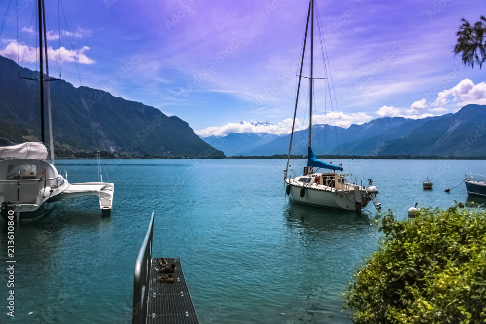 Scenic view of a lake with boats and mountains