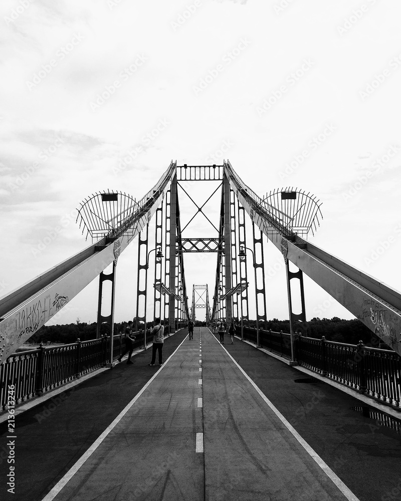 Fototapeta premium A footbridge- is a bridge designed solely for pedestrians. The pedestrian bridge in Kyiv is the only pedestrian bridge across the Dnieper with a length of 430 m, connecting the center of the capital a