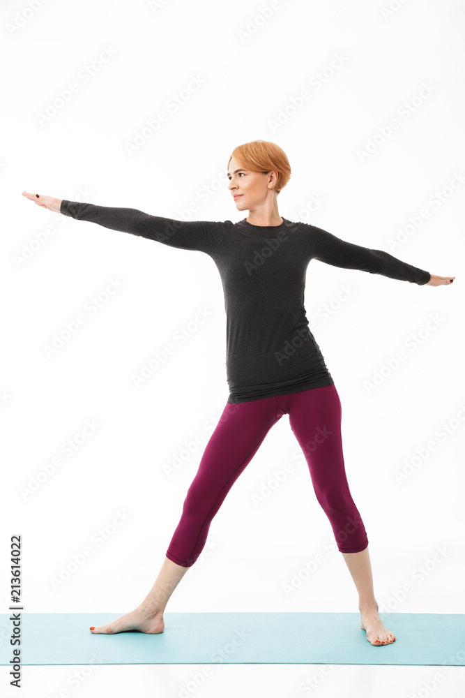 Full length portrait of a concentrated yoga woman