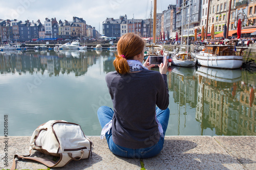 girl taking a shot of Honfleur harbor