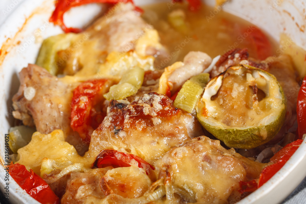 Traditional tasty rustic stew of chicken and vegetables, decorated with tomatoes Traditional tasty rustic stew of chicken and vegetables, decorated with tomatoes