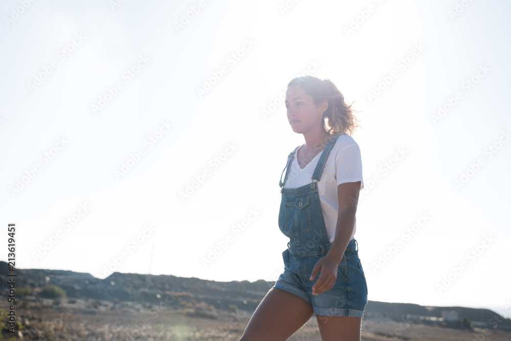 Woman walking in the desert looking up