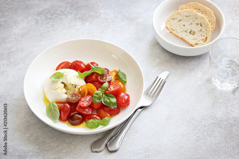 Mozzarella and cherry tomatoes salad with fresh basil and olives. Mozzarella and cherry tomatoes salad with fresh basil and olives.
