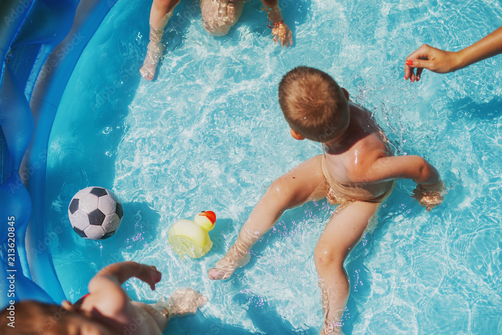 Baby kids playing at baby pool at backyard. Kids pool having fun ...