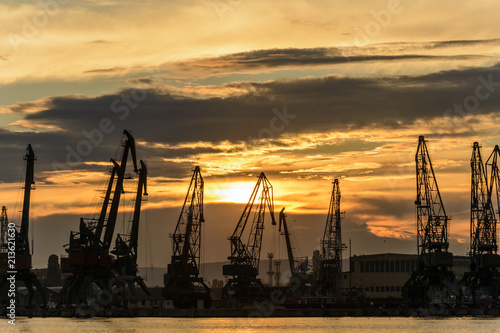 Cranes silhouette in the Varna Harbor at sunset.