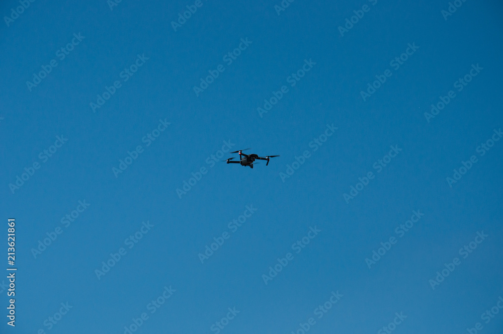 Black quadrupter with propellers flies in the sky and photographs landscapes Black quadrupter with propellers flies in the sky and photographs landscapes