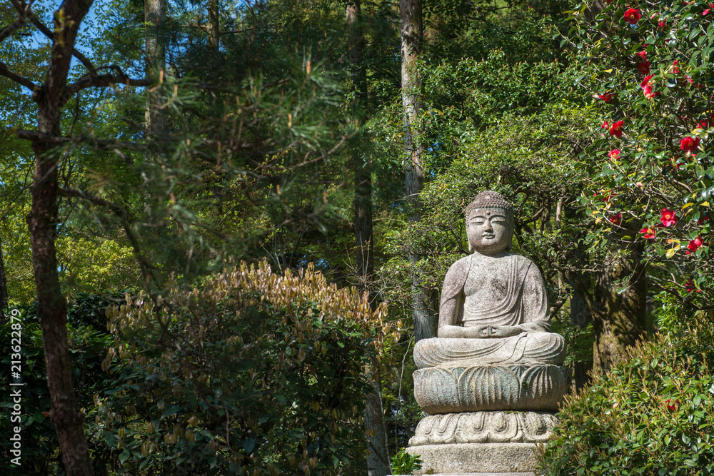 Japanese Buddha statue in a temple garden in Kyoto Japanese Buddha statue in a temple garden in Kyoto