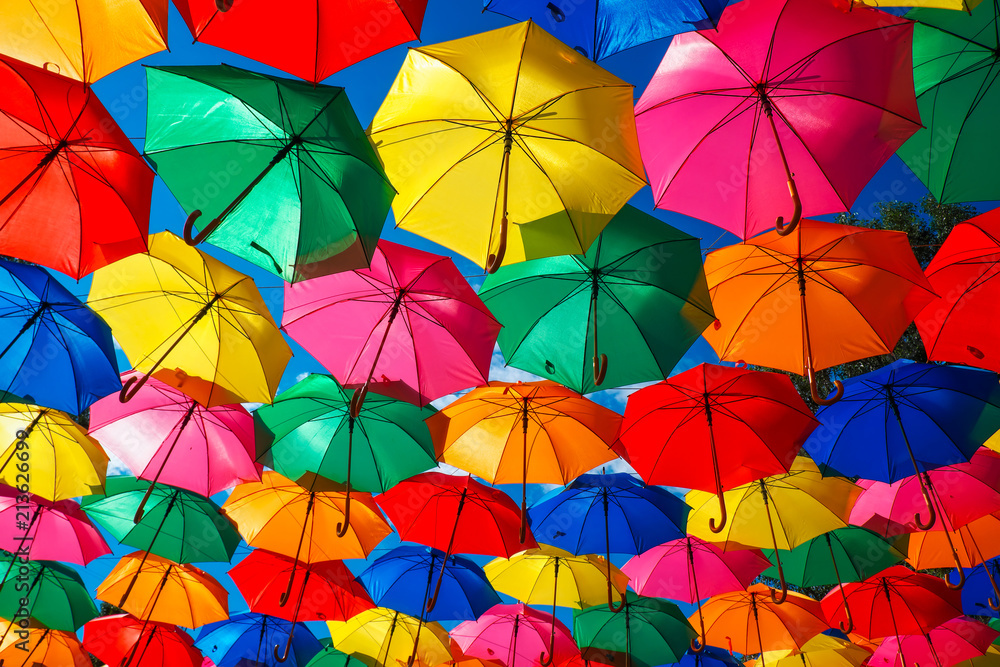 Lots of colorful umbrellas in the sky. City decoration Lots of colorful umbrellas in the sky. City decoration