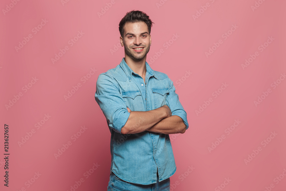 portrait of confident casual man standing with hands folded portrait of confident casual man standing with hands folded