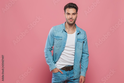 relaxed man wearing denim shirt and jeans standing