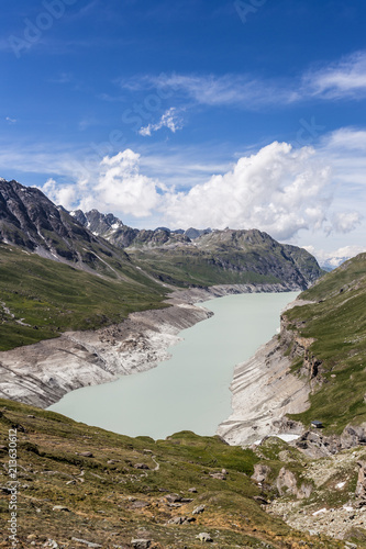 The Grande Dixence lake, formed by a dam, in the Swiss alps in Canton Valais on a sunny summer day