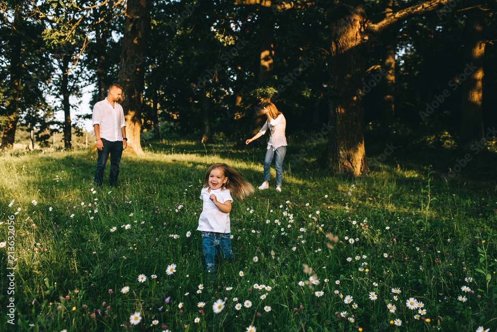 Fototapeta premium beautiful family having fun together in forest on summer day