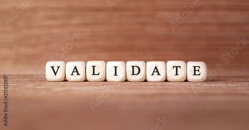 Word VALIDATE made with wood building blocks
