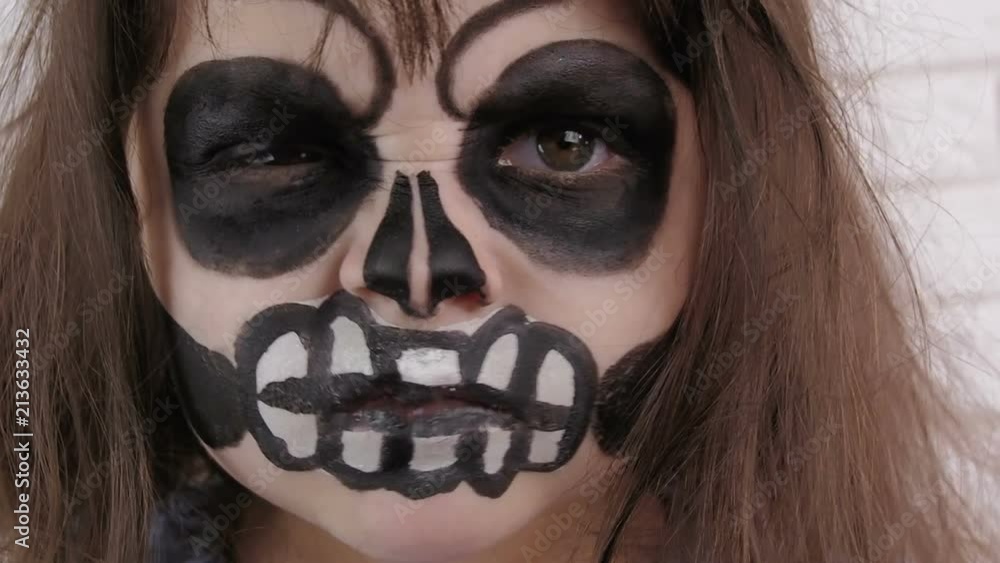 Day of the Dead. Halloween. Angry child. Drawing on the face. Day of the Dead. Halloween. Angry child. Drawing on the face.