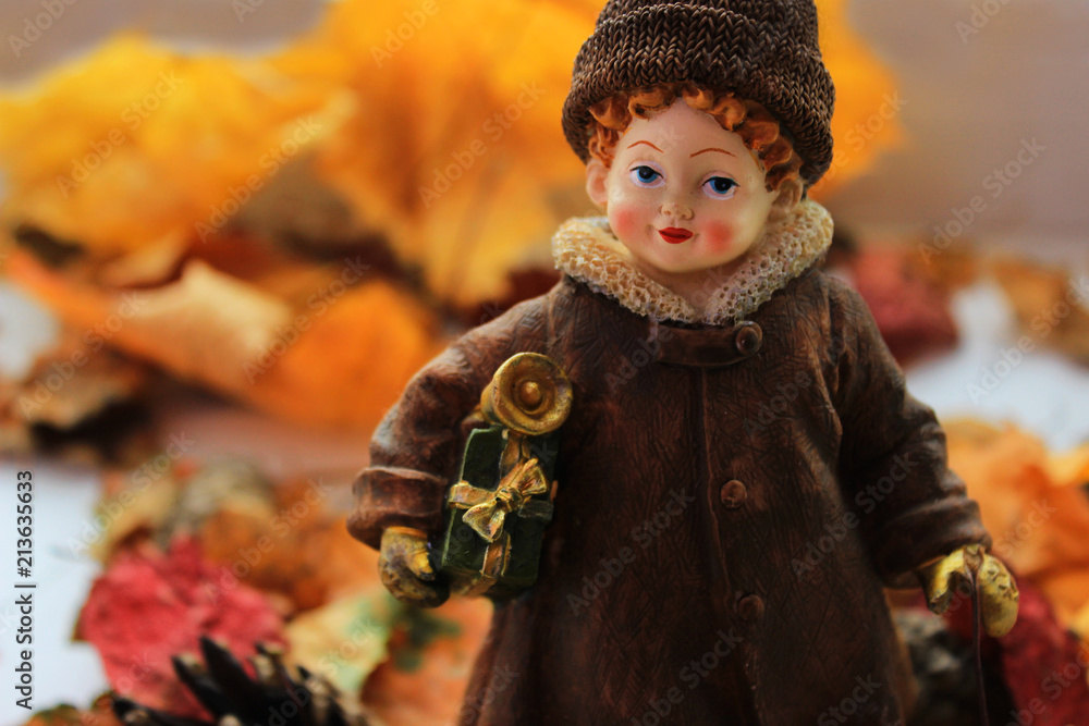 Fototapeta premium Girl with Christmas gifts makes a transition from autumn to winter concept