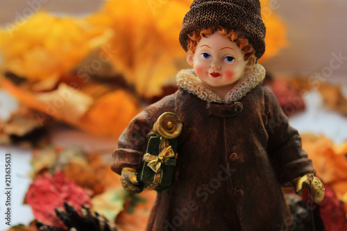 Girl with Christmas gifts makes a transition from autumn to winter concept